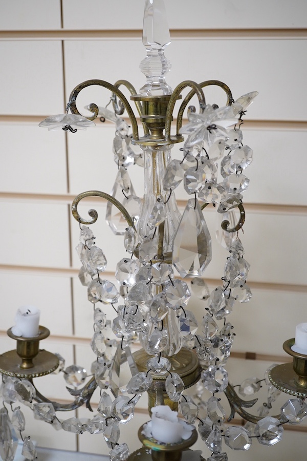 A pair of brass four branch candelabra with glass drops, 61cm high. Condition - fair